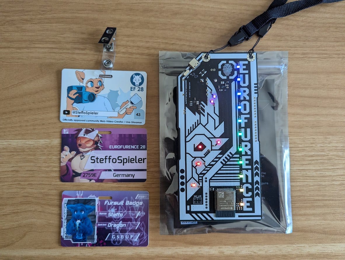 A picture showing all 4 badges on a wooden desk.