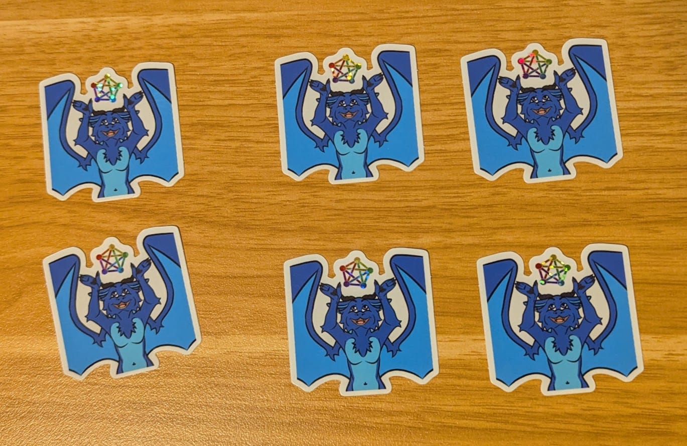 A picture of the 6 remaining stickers of my dragon holding the Fediverse icon.